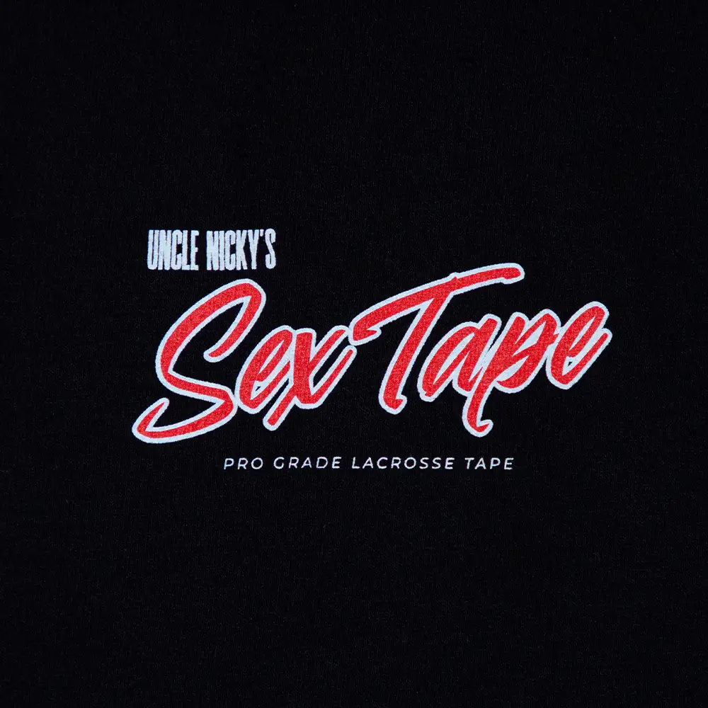 Close-up of Uncle Nicky’s Sex Tape logo in red and white on a black t-shirt, reading “Pro Grade Lacrosse Tape”