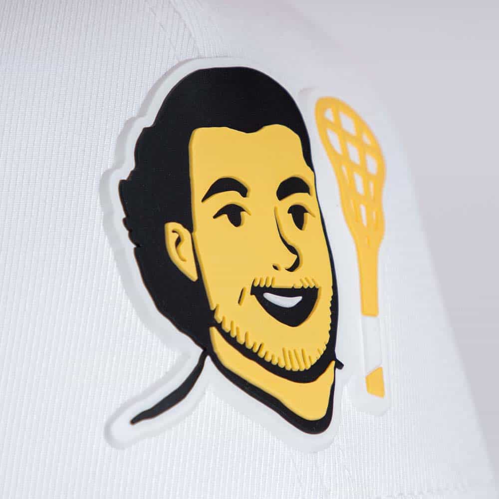 Close-up of Uncle Nicky hat logo with face and yellow lacrosse stick